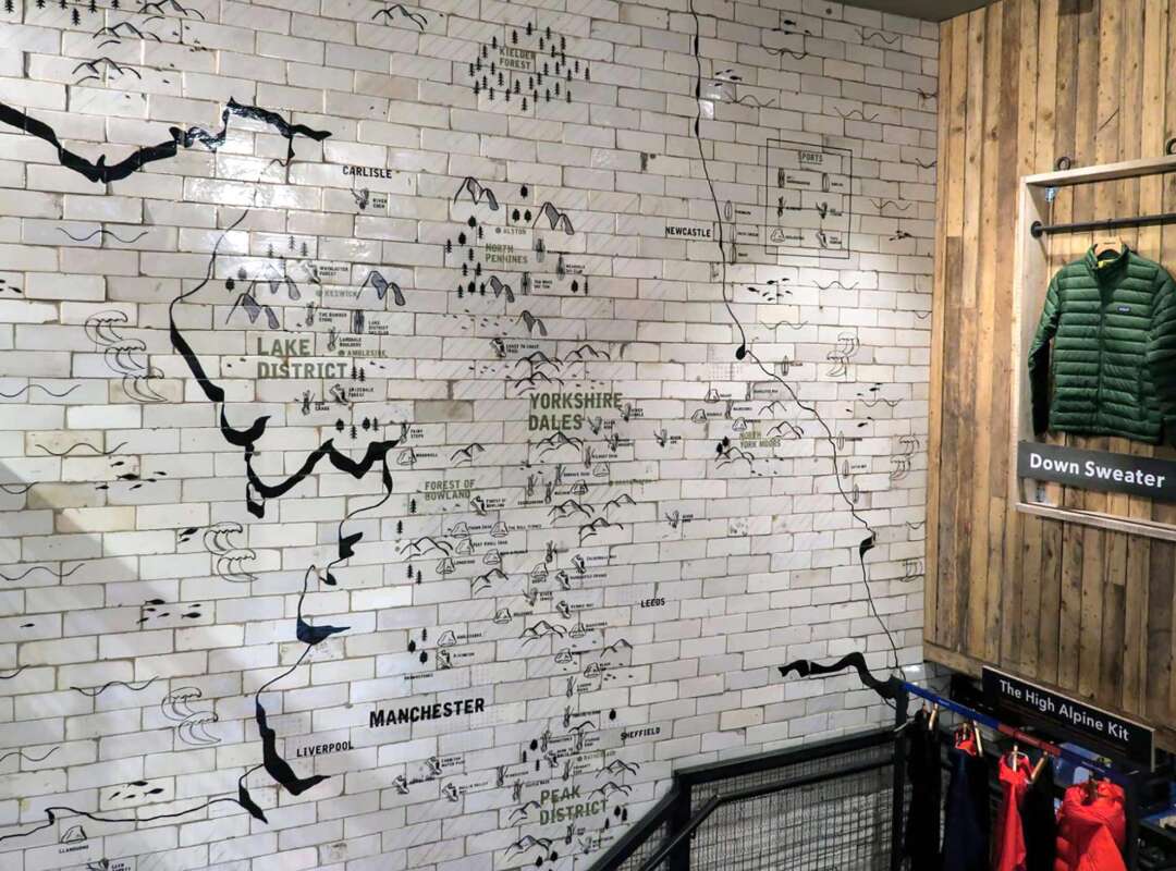 Patagonia Manchester Store – Hand Painted Tile Map Stairwell Hand painted wall map across reclaimed tiles inside the Patagonia Manchester store stairwell
