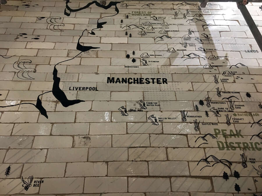 Painted Manchester map typography on tiled wall graphic inside Patagonia Manchester store