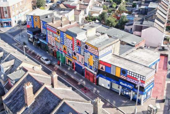 Aerial view of Walala Parade mural by Camille Walala covering a full parade of buildings on Leyton High Road London