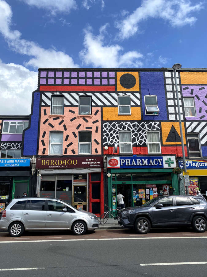 Camille Walala mural artwork across shopfront buildings on Leyton High Road London