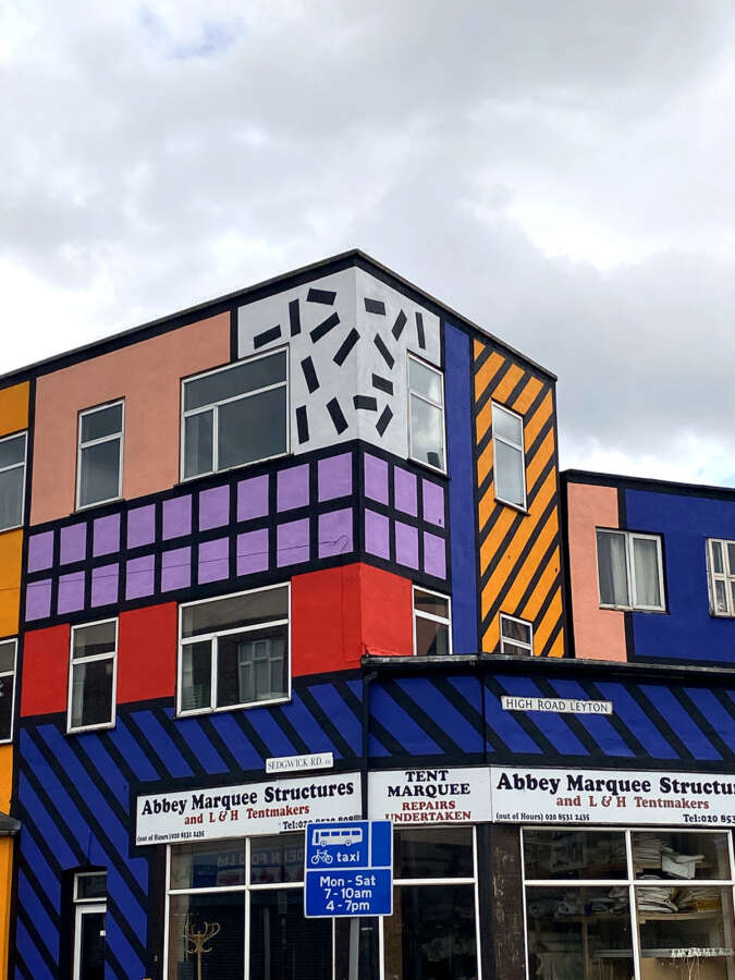 Corner section of Walala Parade mural by Camille Walala showing geometric patterns across building facade