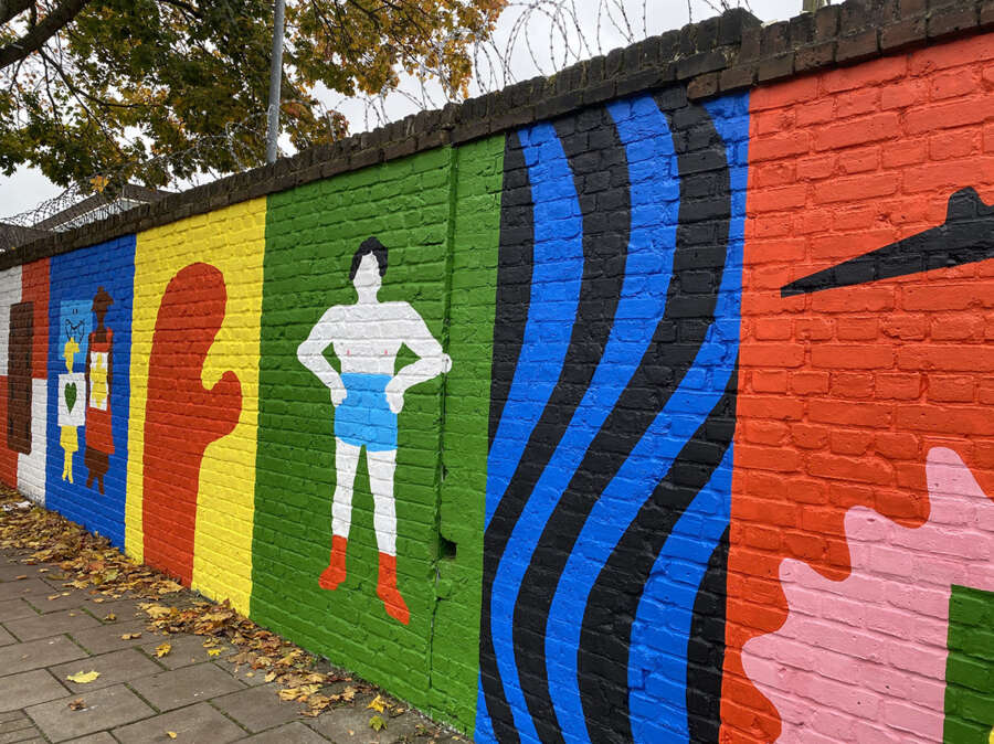 Painted figure and abstract shapes from Alec Doherty public art mural in Bermondsey
