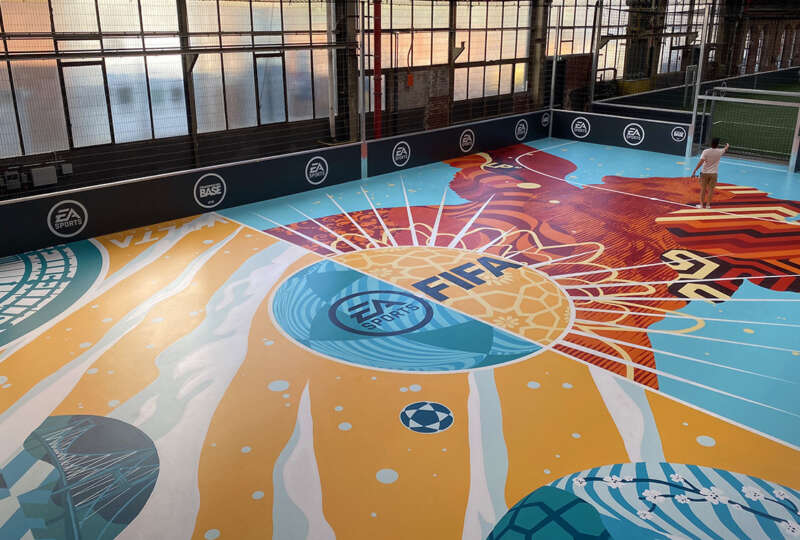 Full indoor football court mural designed by Tristan Eaton at Strassenkicker Base in Cologne