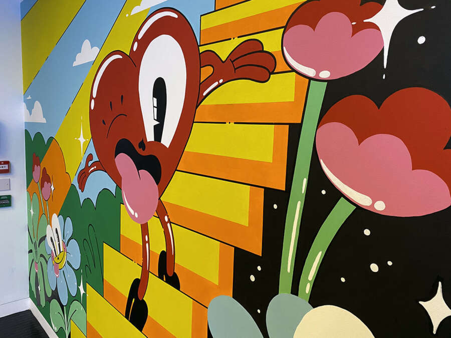 Detail of Hattie Stewart mural showing illustrated heart character and staircase design