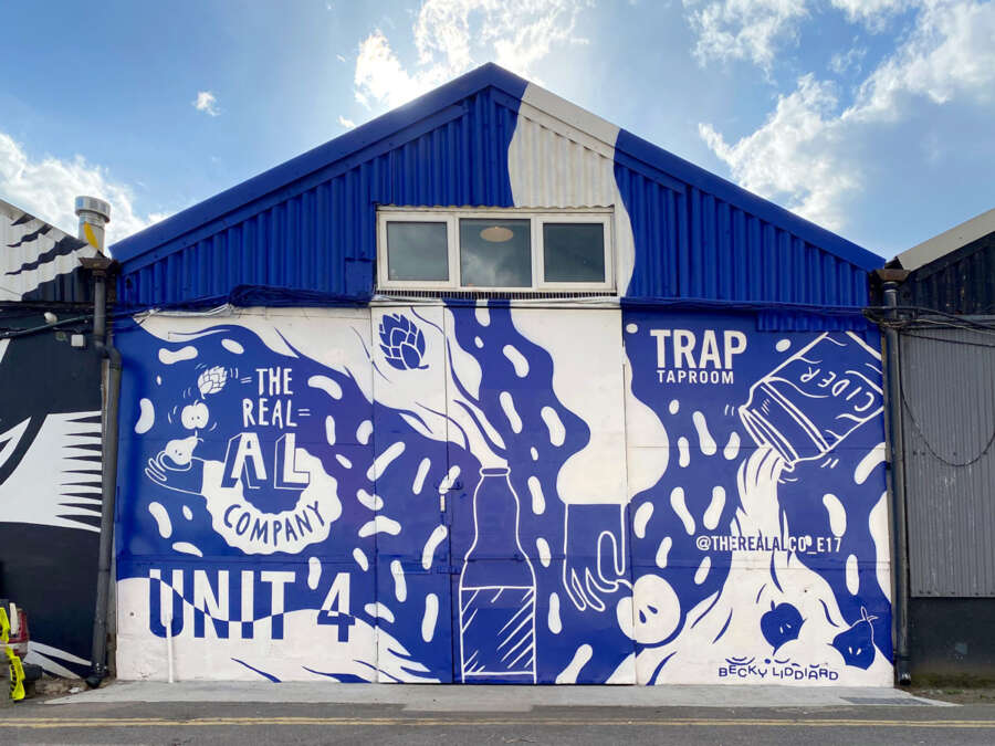 Large-scale hand-painted mural by Becky Liddiard on The Real Al Co building in Walthamstow London produced by Absolutely Studio