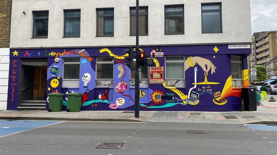 Public art mural by Hannah Hill spanning the length of a building façade in Bankside