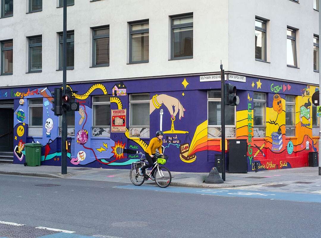 Street view of Hannah Hill mural wrapping the side of a building in Bankside London