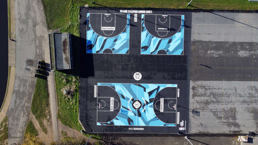 Drone view of painted basketball courts at Clapham Common including one full court and two half courts
