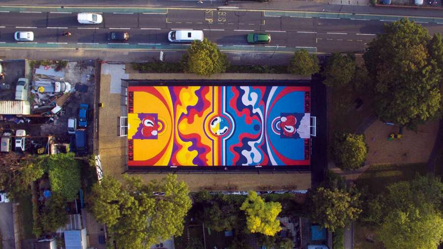 Aerial view of painted basketball court mural at Orchard Park Portsmouth designed by Hattie Stewart
