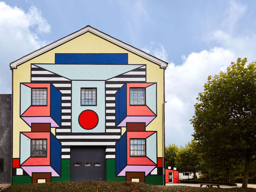 Camille Walala building wrap on Montana Furniture factory façade in Haarby Denmark