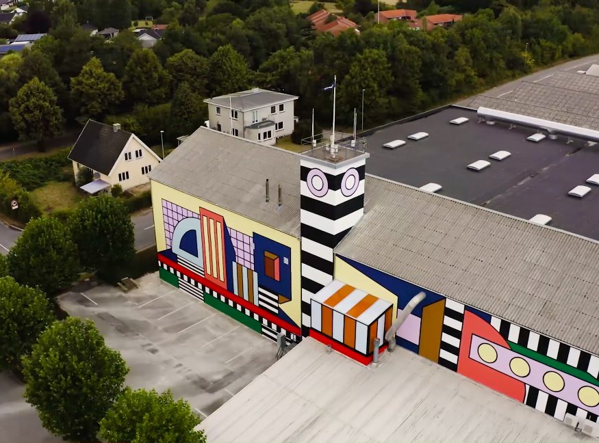 Aerial view of Camille Walala building wrap installation on Montana Furniture factory in Denmark