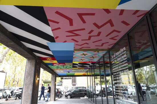 Wide view of painted ceiling mural by UNO spanning the CitizenM Rome entrance corridor