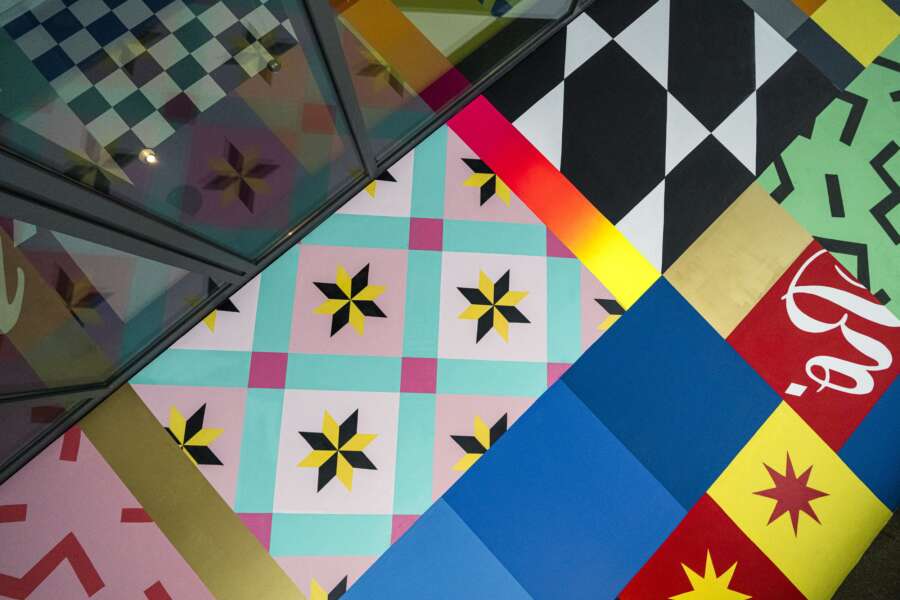 Close-up detail of geometric patterns in the UNO ceiling mural at CitizenM Rome