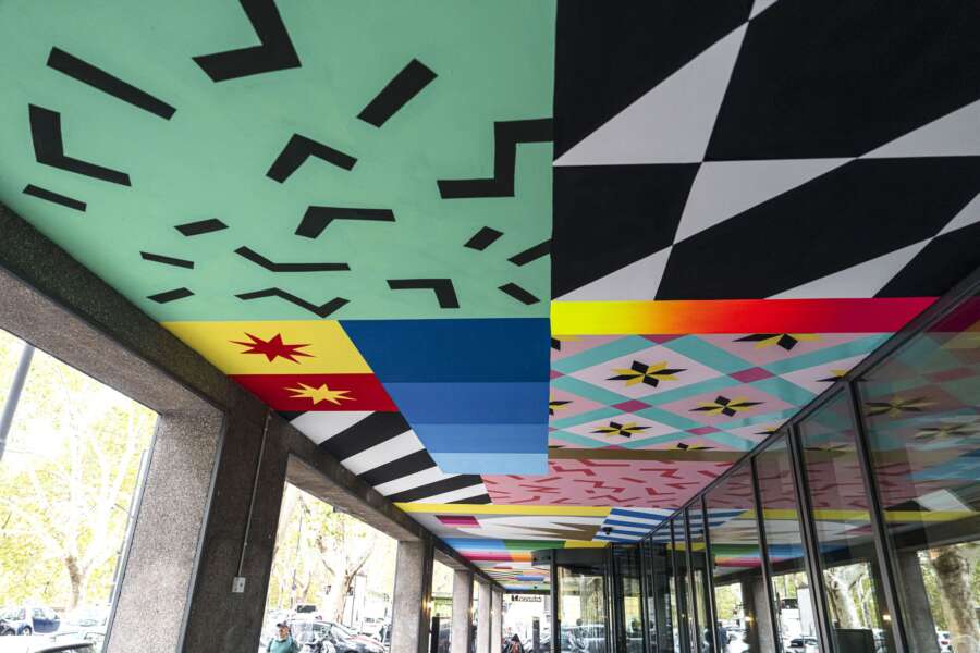 Geometric patterns and colour blocks in ceiling mural by UNO at CitizenM Rome