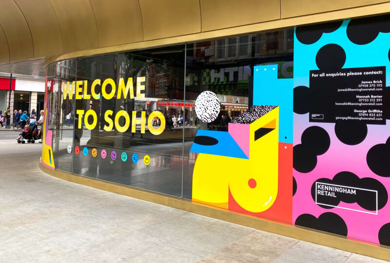 Colourful vinyl mural by Darren John featuring Welcome to Soho message on development hoarding in central London