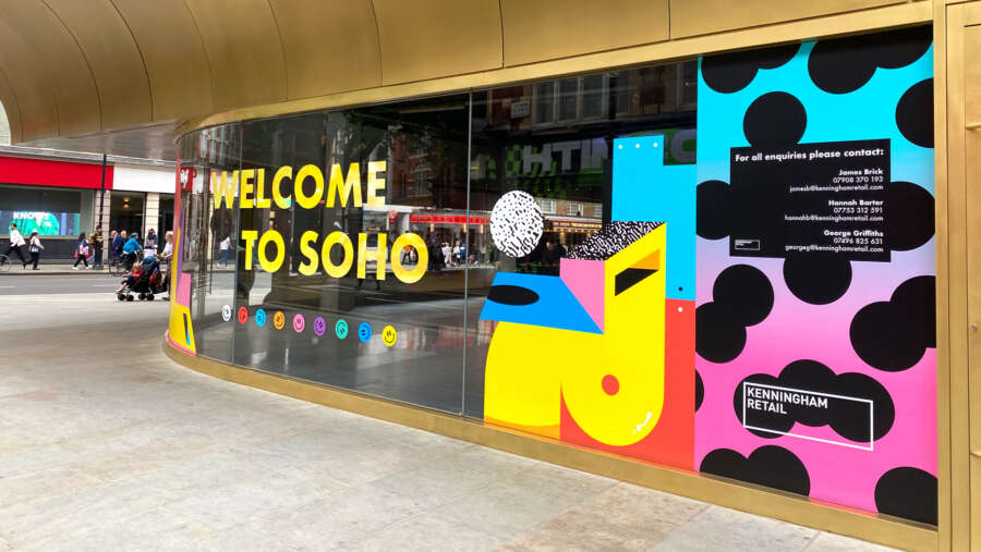 Colourful vinyl mural by Darren John featuring Welcome to Soho message on development hoarding in central London