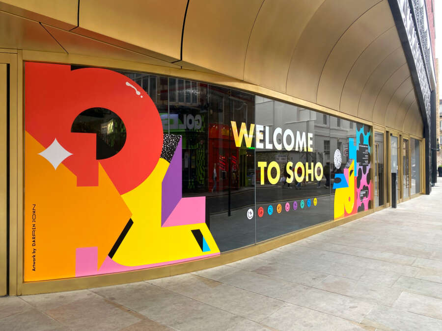 Detail of Darren John vinyl mural installation wrapping building hoarding in Soho