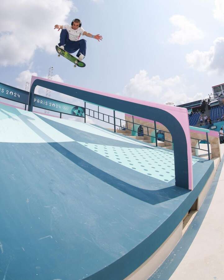 Skateboarder performing trick on painted ramp at the Paris 2024 Olympic skatepark