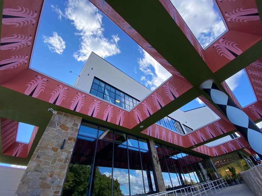 Upward view of painted canopy mural beams and columns on Boston building exterior
