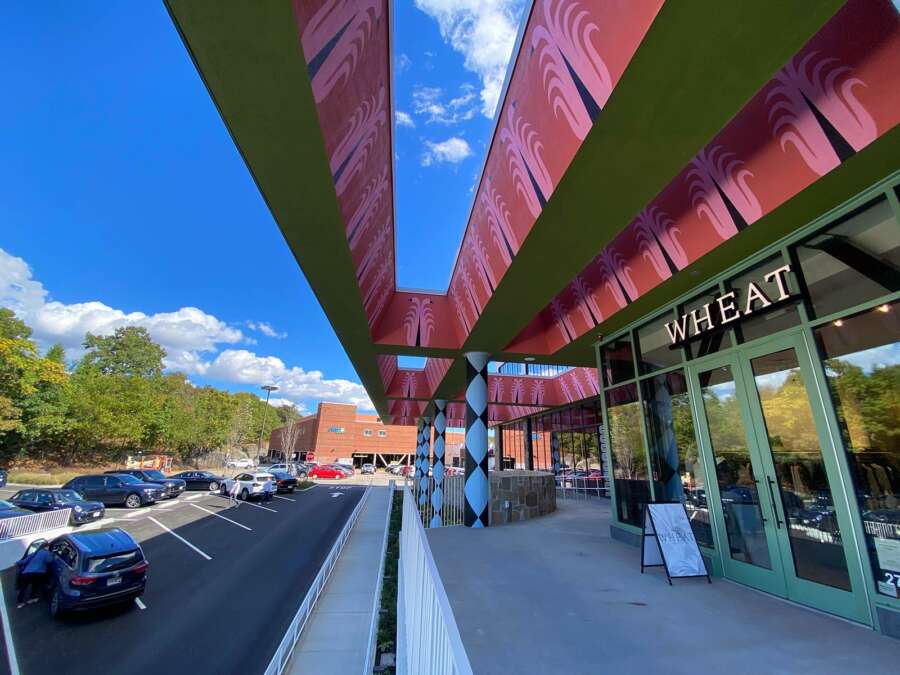 Wide exterior view of large-scale painted canopy mural installed on building in Boston