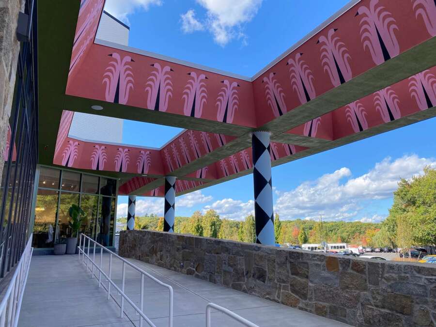 Exterior walkway beneath painted canopy mural installation in Boston
