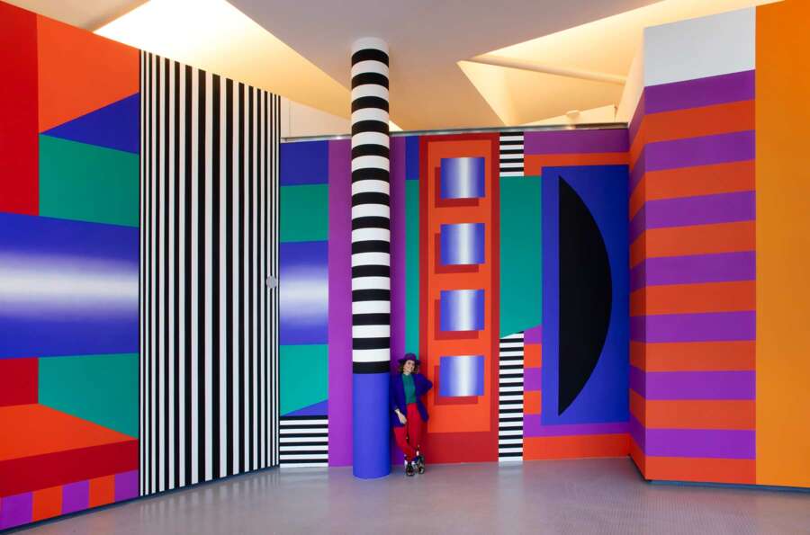 Large-scale interior installation by Camille Walala at The Lowry in Salford featuring bold geometric patterns and striped columns