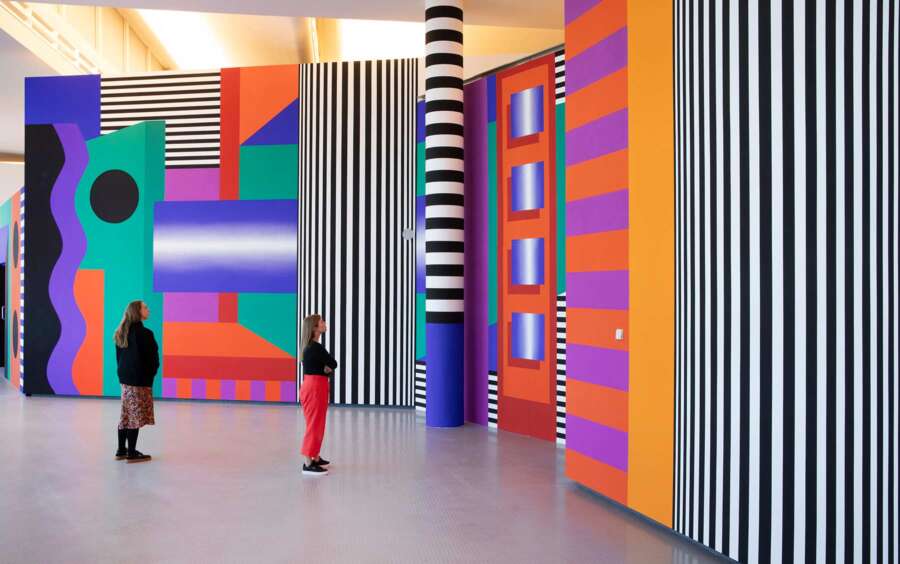 Wide view of Camille Walala installation at The Lowry featuring striped columns and colourful architectural patterns