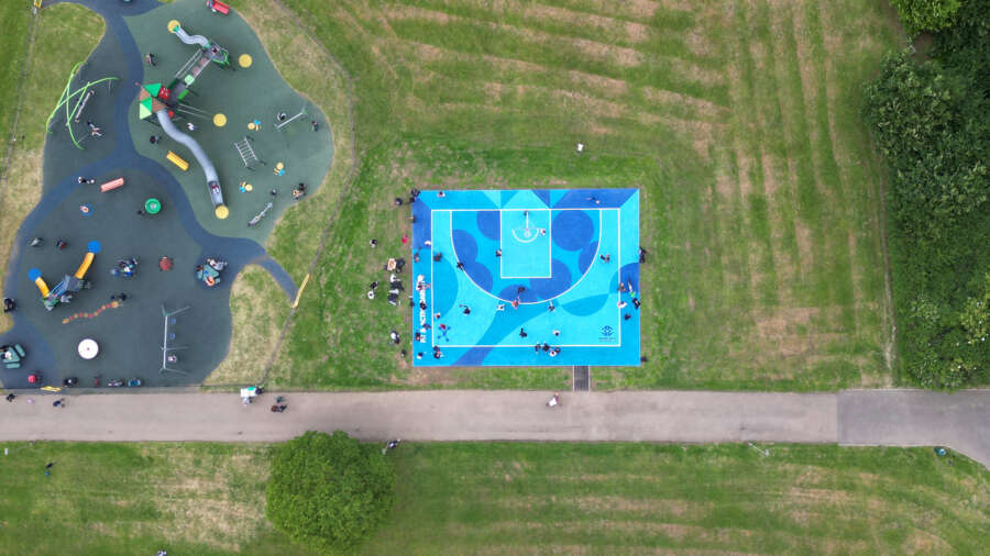 Overhead aerial view of Darren John basketball court mural in Barnet community park