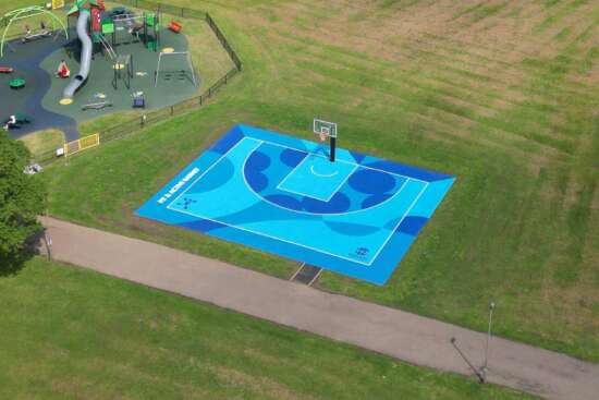 Aerial view of painted basketball court mural by Darren John in Barnet park, North London