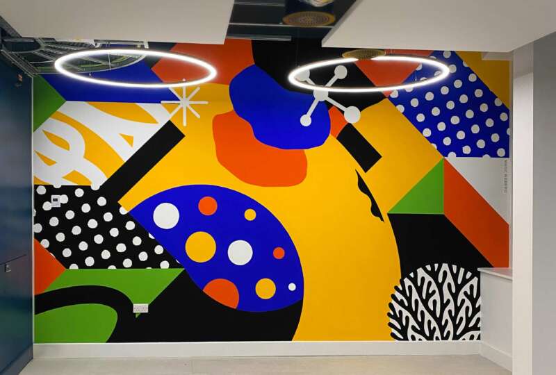 Interior office mural at LSHTM by Darren John, painted with Bristol Paints in vibrant abstract shapes.