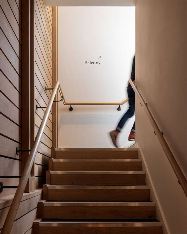 Hand painted balcony wayfinding text applied directly to wall inside Brighton Dome
