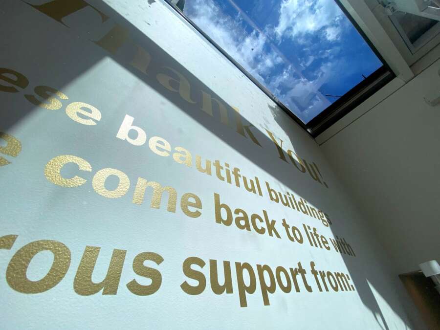 Close detail of hand painted gold donor wall lettering inside Brighton Dome