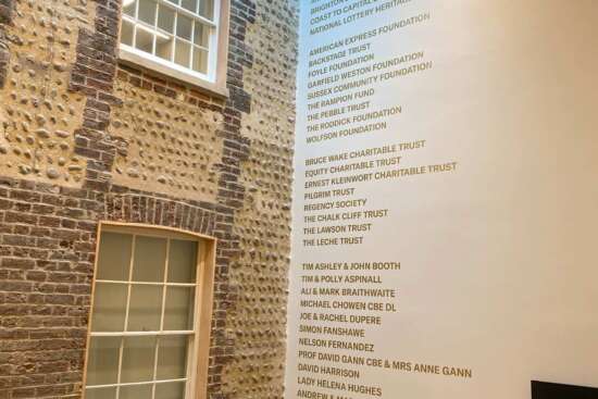 Large hand painted donor wall spanning multiple floors inside Brighton Dome