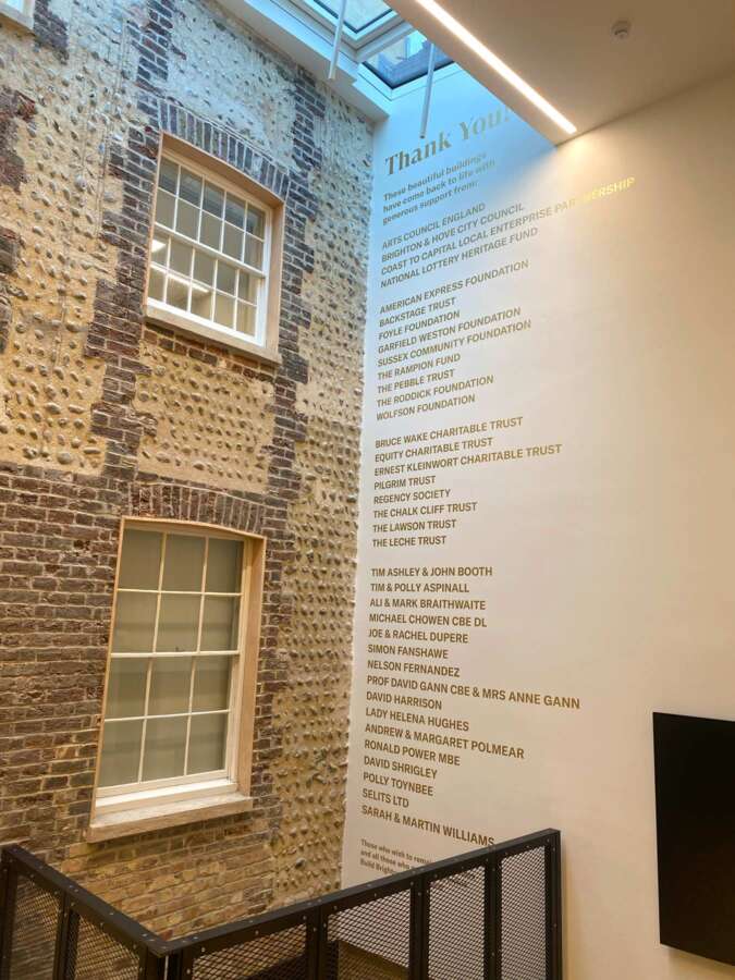 Large hand painted donor wall spanning multiple floors inside Brighton Dome