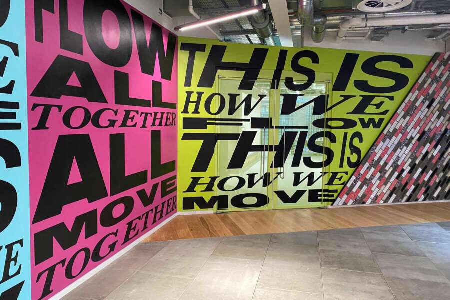 Bold typographic mural artwork installed across interior walls at Nike headquarters