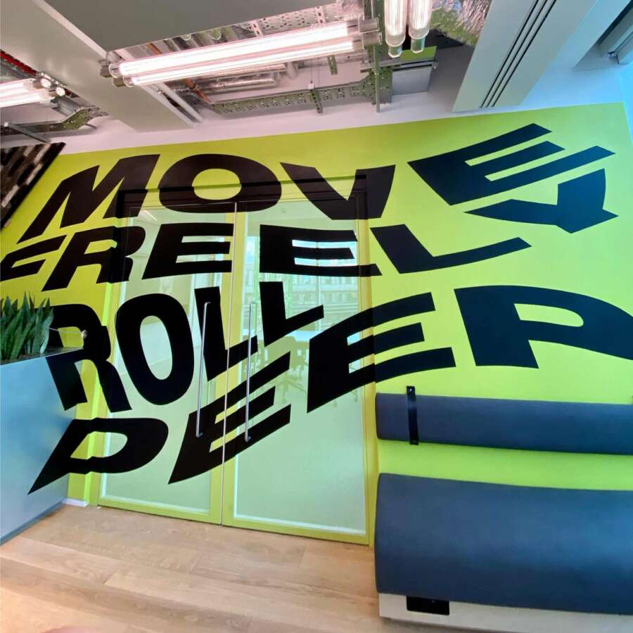 Bold typographic mural by Lakwena installed inside Nike headquarters London