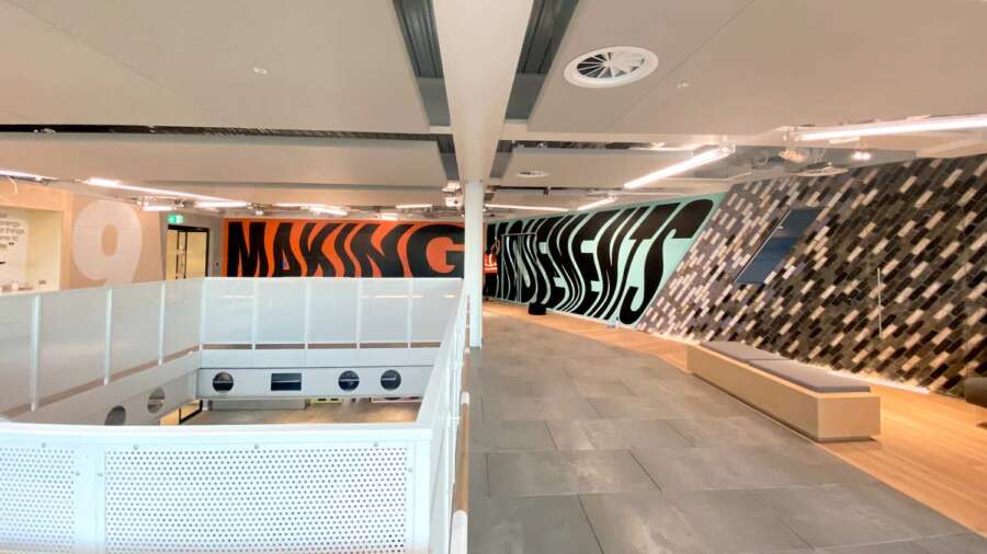 Interior view of typographic mural artwork by Lakwena inside Nike headquarters London