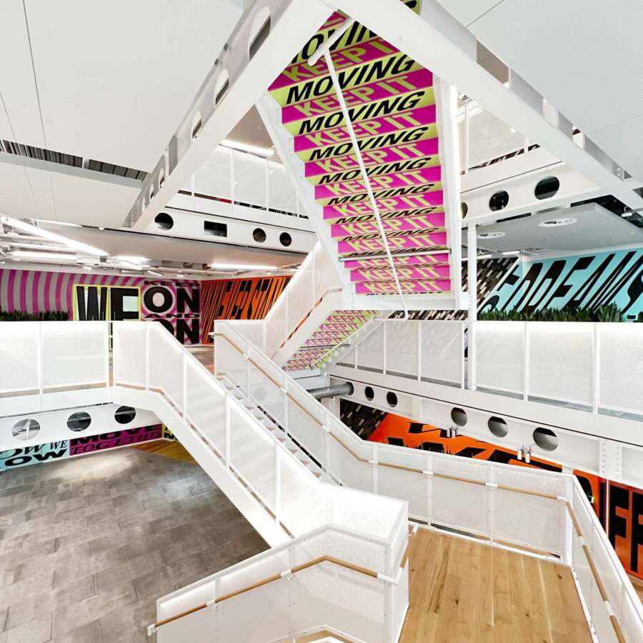 Large scale mural installation across multiple floors inside Nike headquarters in Kings Cross London