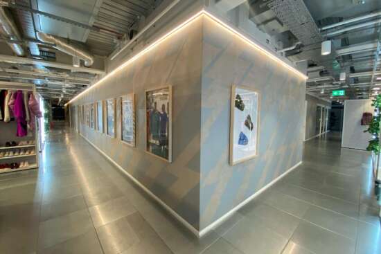 Hand painted chevron wall graphics applied directly to textured concrete inside Nike London headquarters showroom