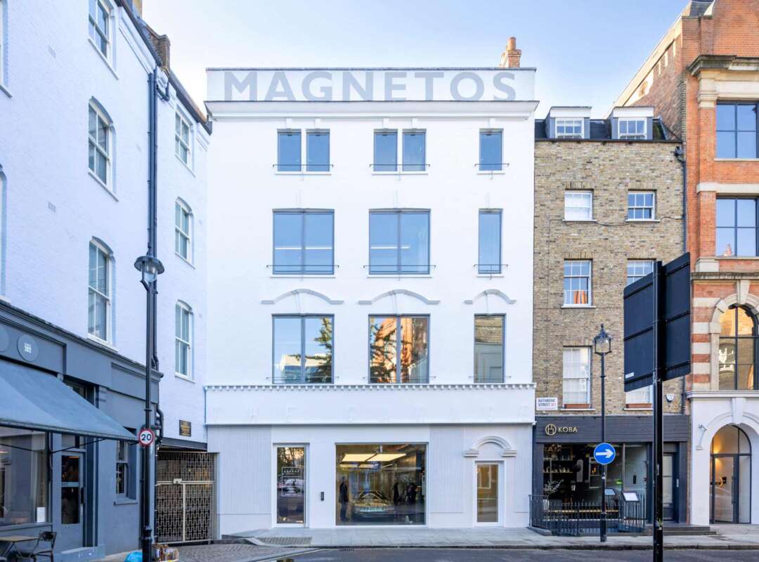 Hand painted Magnetos parapet signage Rathbone Street Garage London Hand painted Magnetos lettering recreated on rooftop parapet of restored garage building in Fitzrovia London